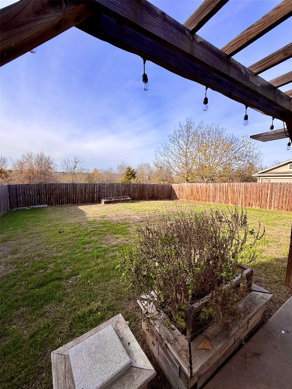 18304 Belfry Pass Manor, TX 78653 - Photo 24 of 26 Fenced backyard with a pergola and a patio