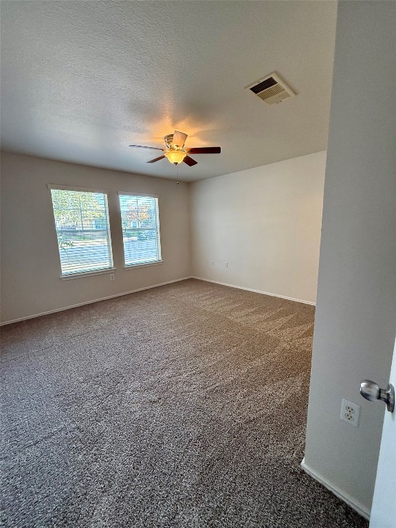 18304 Belfry Pass Manor, TX 78653 - Photo 7 of 26 Empty room featuring carpet flooring, a textured ceiling, and a ceiling fan