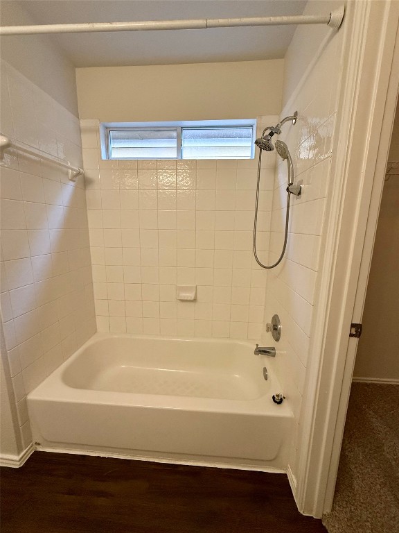 18304 Belfry Pass Manor, TX 78653 - Photo 10 of 26 Bathroom with shower combination and dark wood-type flooring
