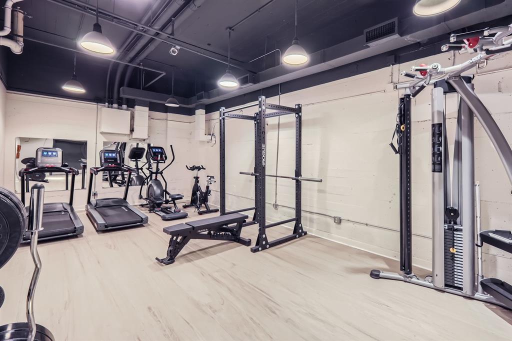 710 Colorado Street, Unit 4J Austin, TX 78701 - Photo 29 of 37 Workout area featuring visible vents and wood finished floors