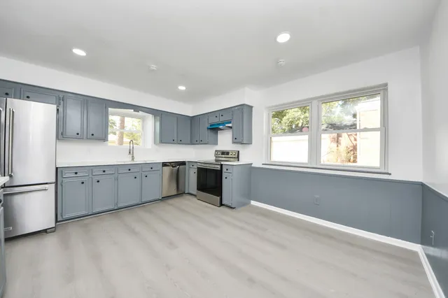 a kitchen with a white cabinets and refrigerator