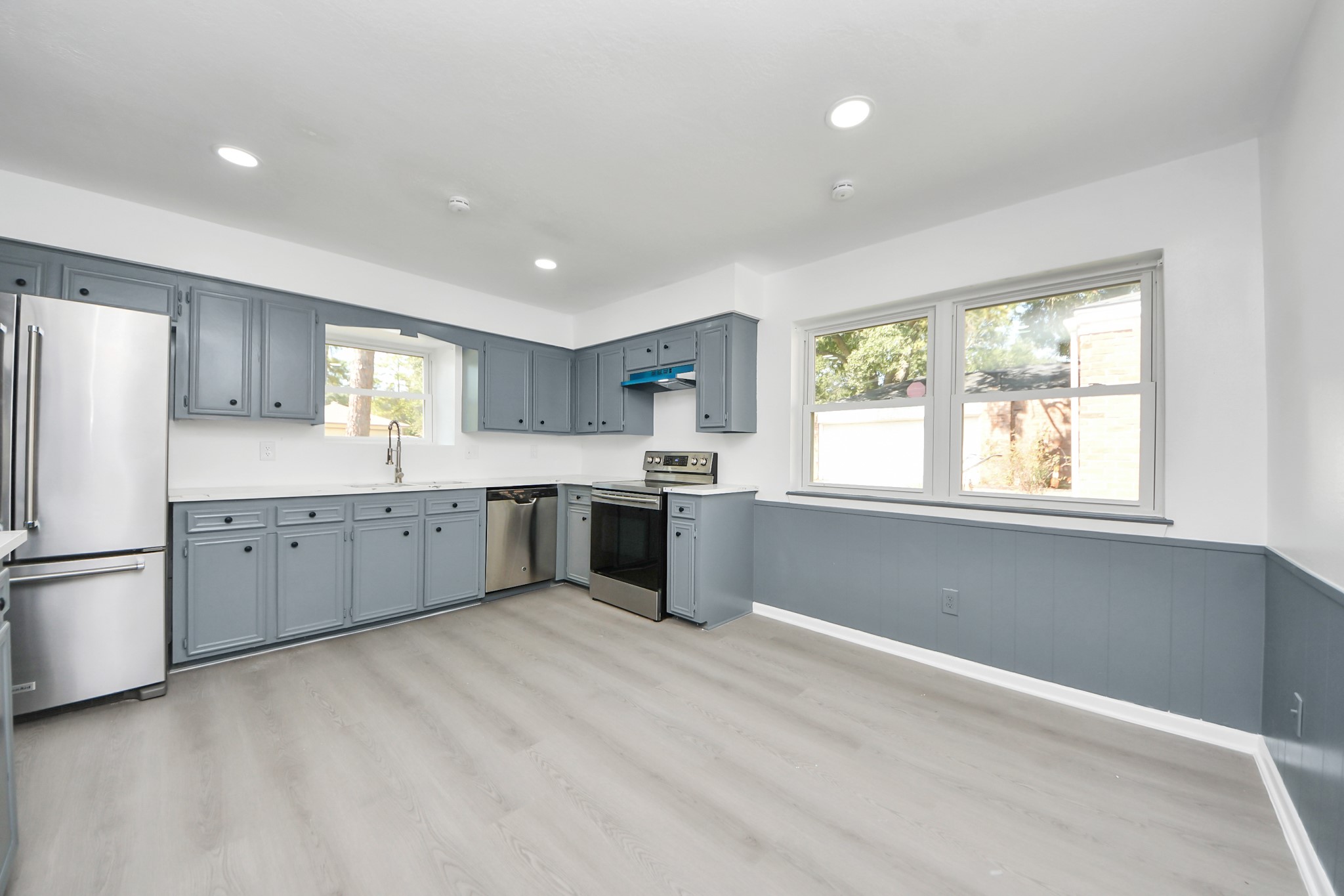 23002 Grand Rapids Lane Spring, TX 77373 - Photo 11 of 41 a kitchen with a white cabinets and refrigerator