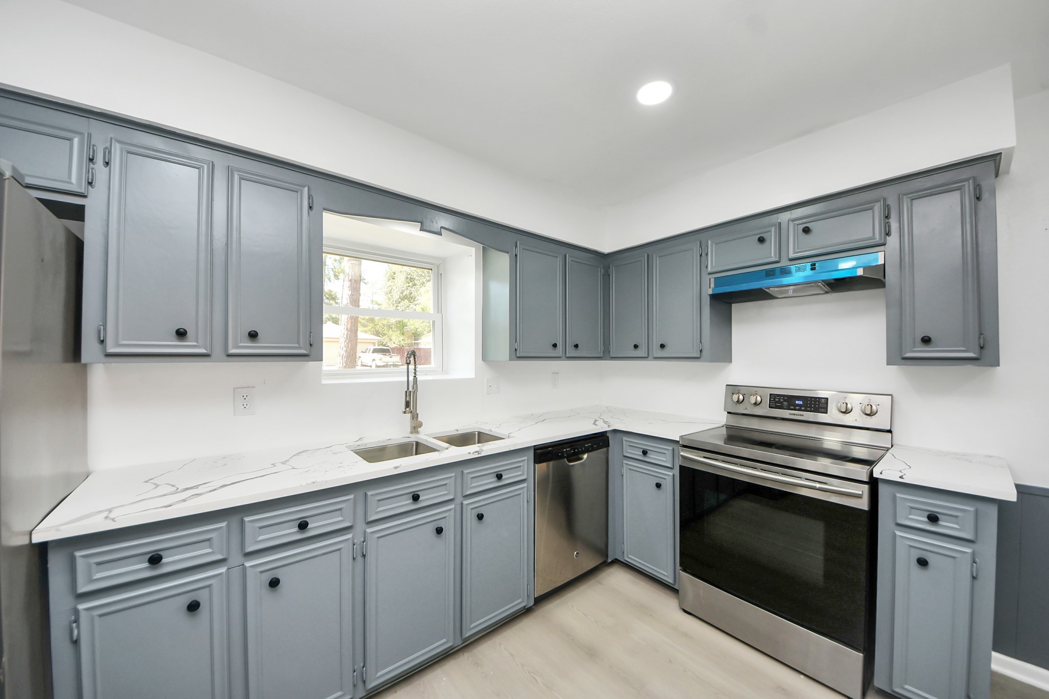 23002 Grand Rapids Lane Spring, TX 77373 - Photo 12 of 41 a kitchen with appliances cabinets and a sink