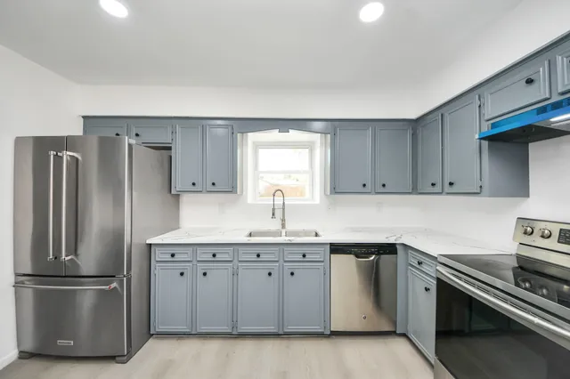 a kitchen with a sink stainless steel appliances and cabinets