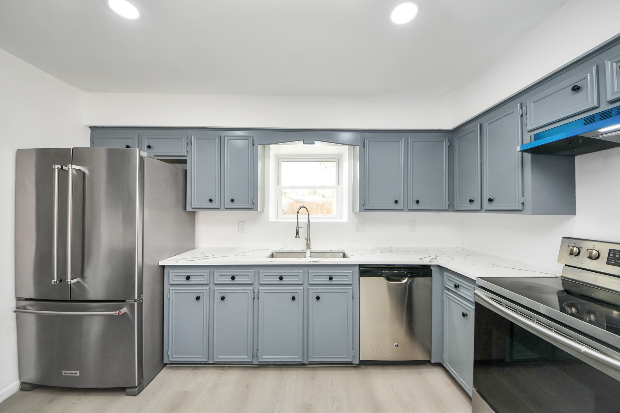 23002 Grand Rapids Lane Spring, TX 77373 - Photo 13 of 41 a kitchen with a sink stainless steel appliances and cabinets