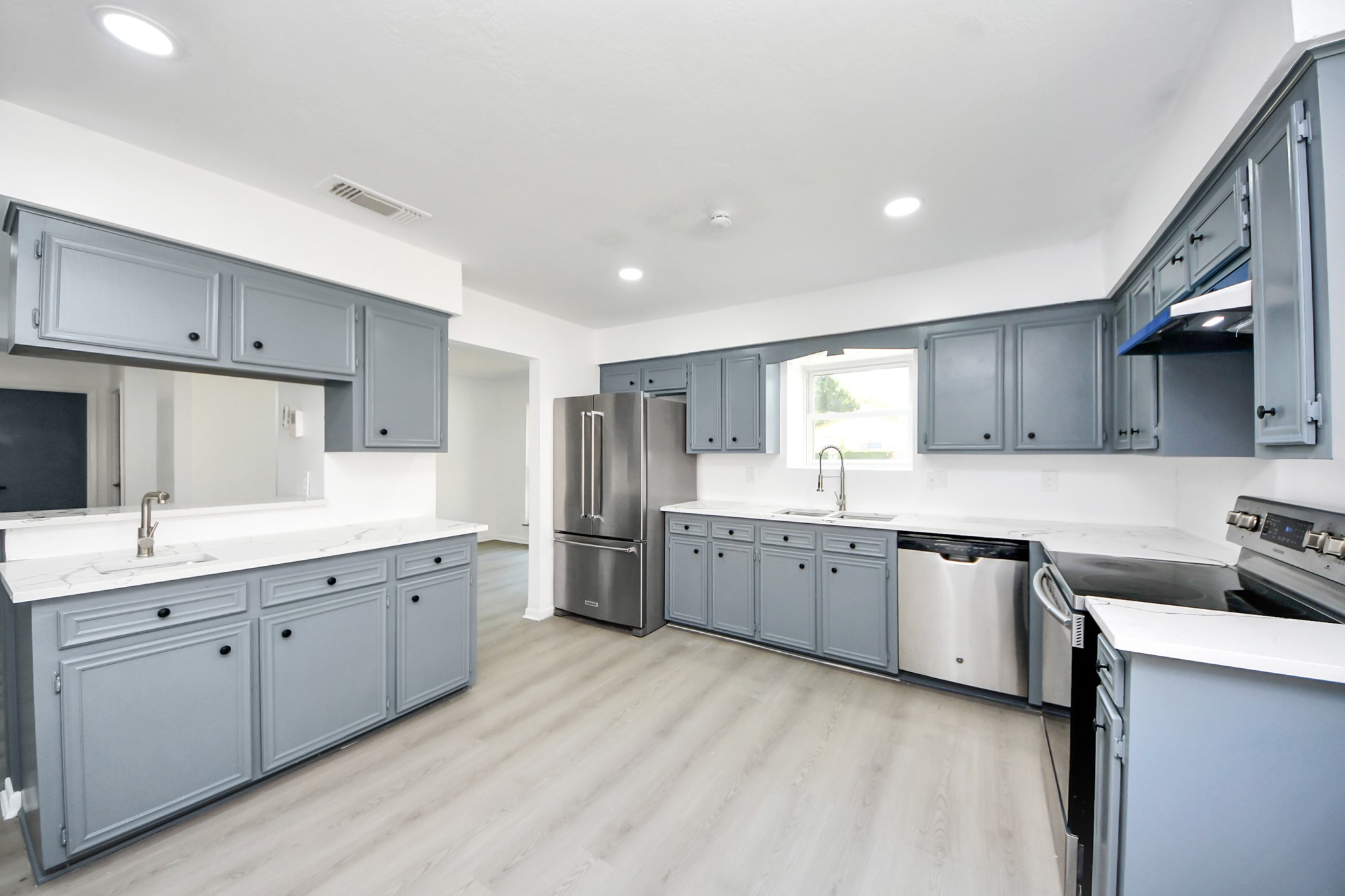 23002 Grand Rapids Lane Spring, TX 77373 - Photo 15 of 41 a kitchen with granite countertop a sink stove top oven and cabinets
