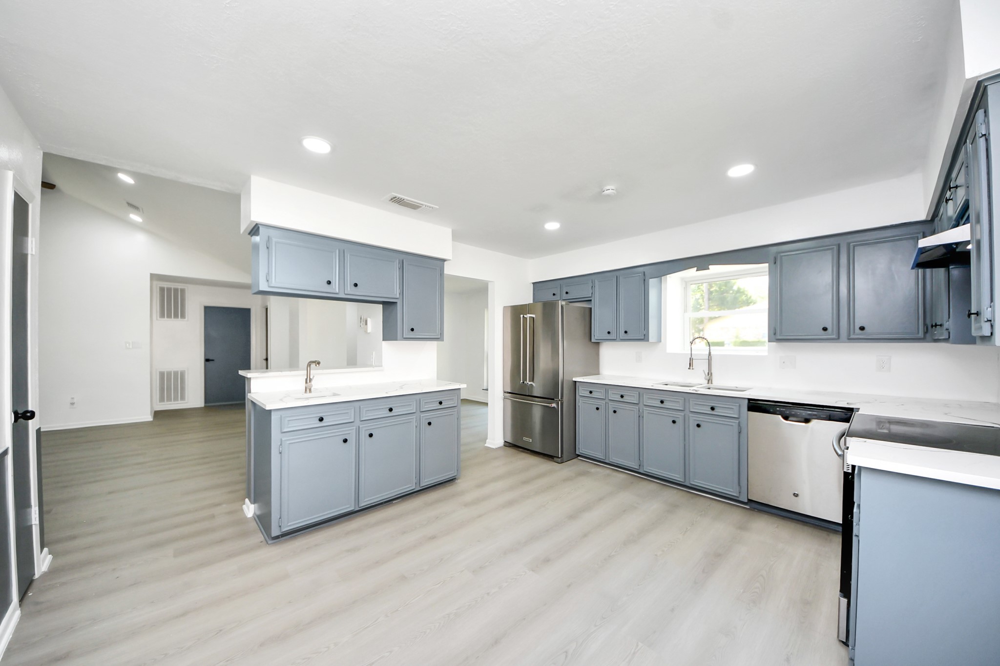 23002 Grand Rapids Lane Spring, TX 77373 - Photo 17 of 41 a large kitchen with a lot of counter space and wooden floor