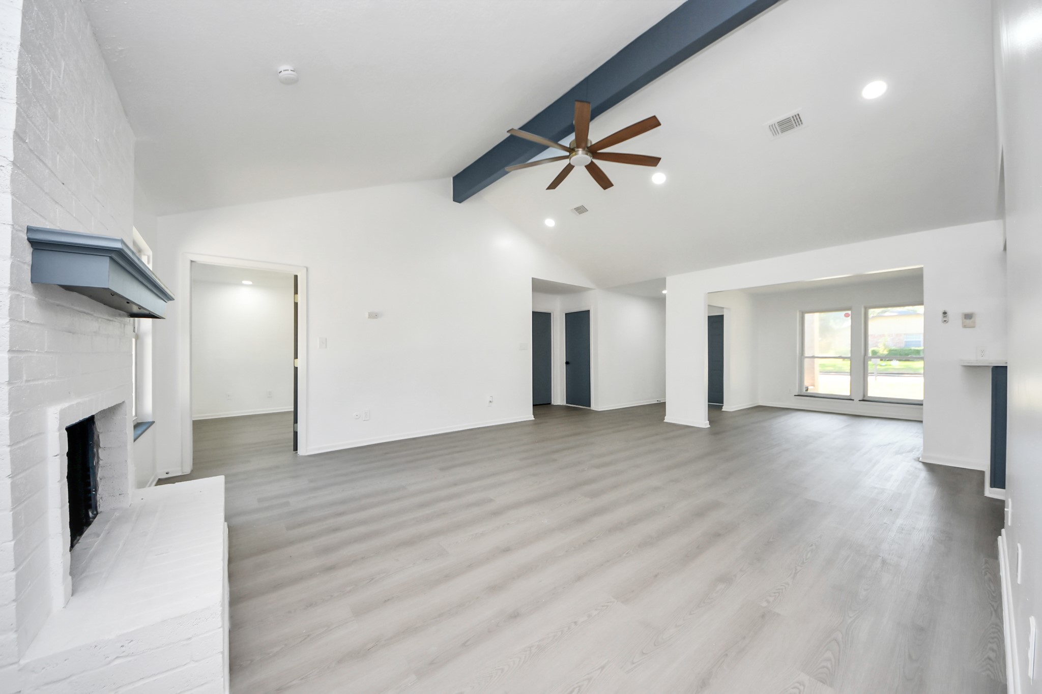 23002 Grand Rapids Lane Spring, TX 77373 - Photo 21 of 41 a view of a livingroom with a fireplace a ceiling fan and windows