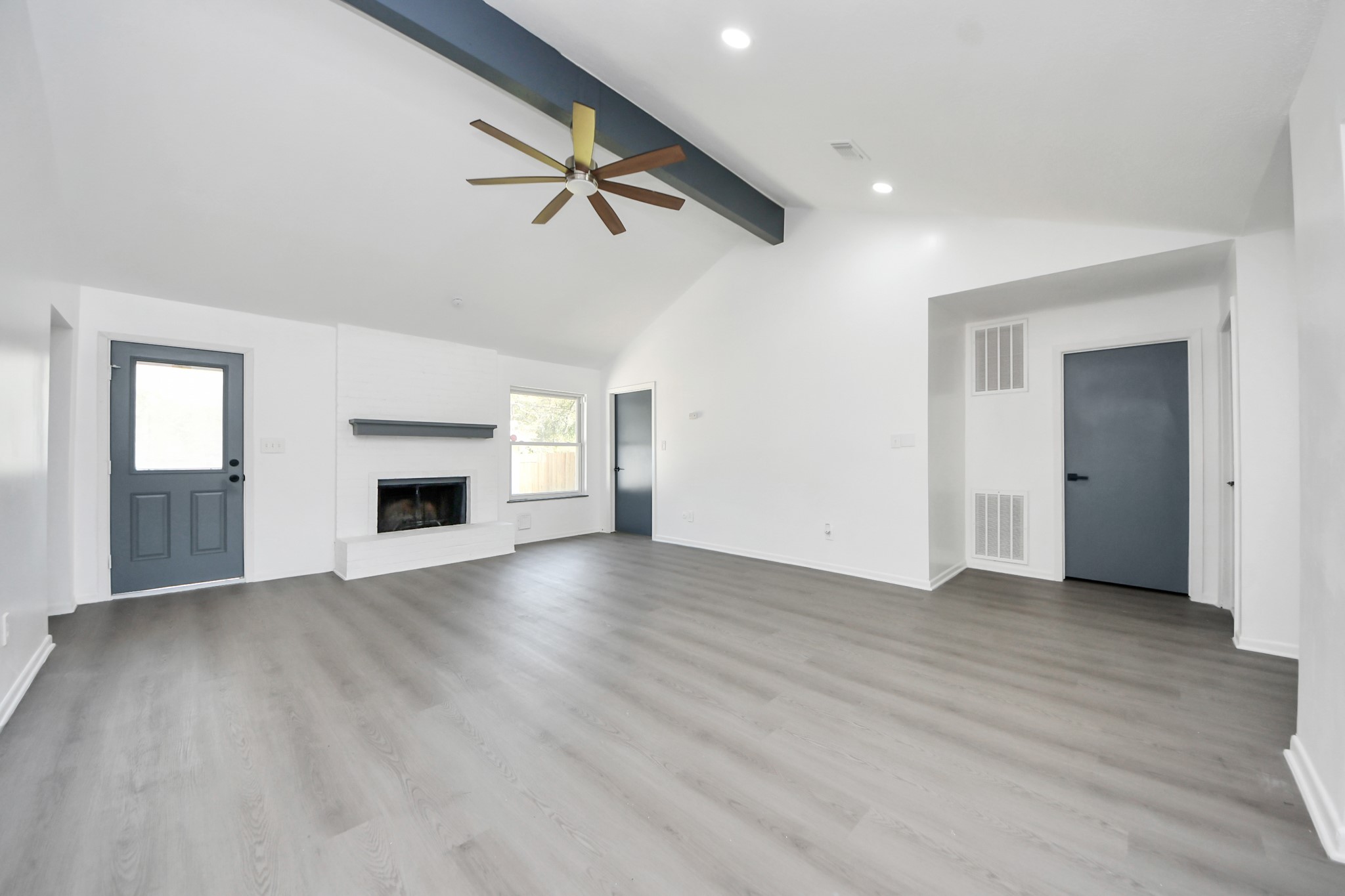 23002 Grand Rapids Lane Spring, TX 77373 - Photo 23 of 41 an empty room with wooden floor fireplace and windows