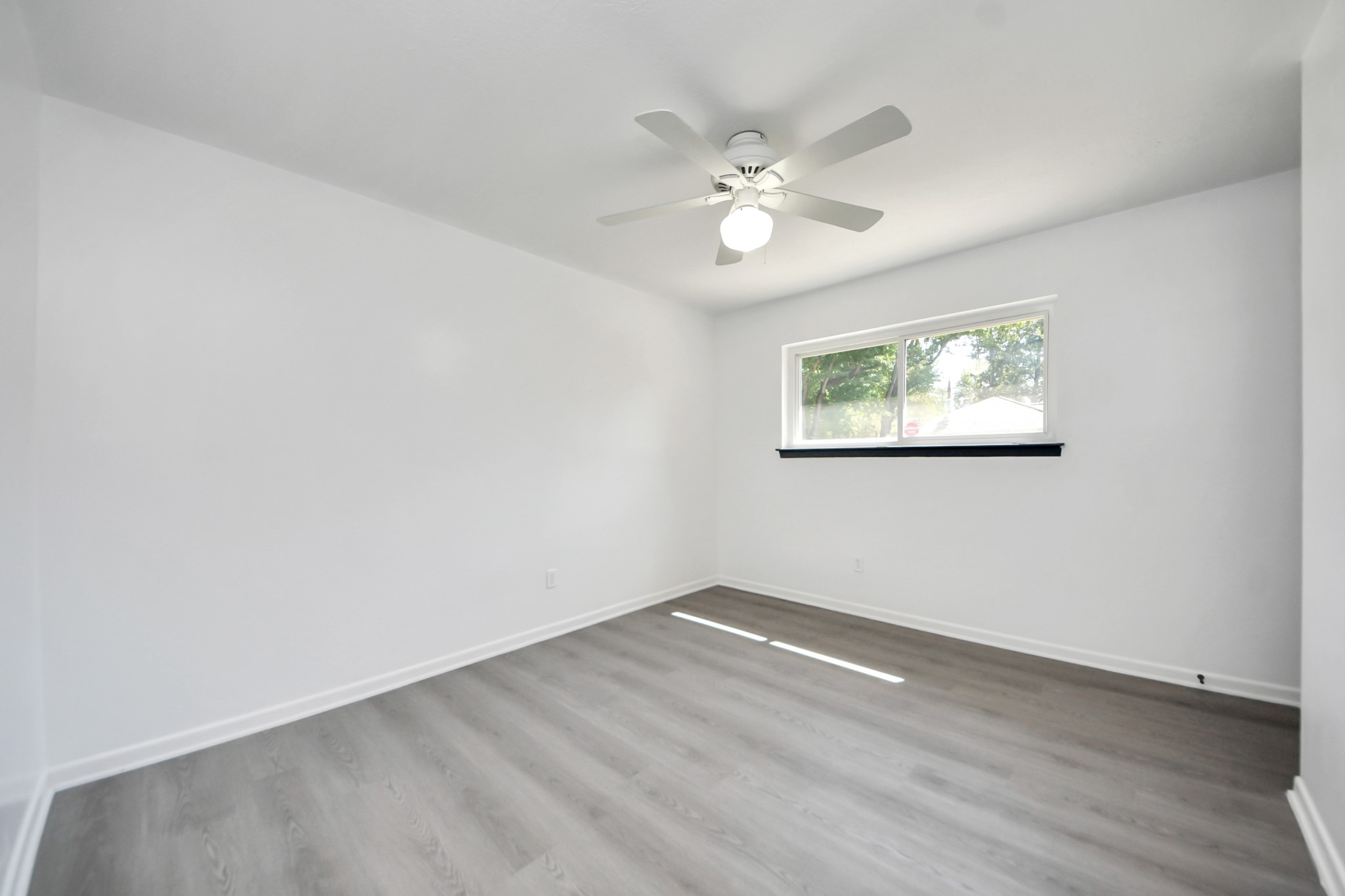 23002 Grand Rapids Lane Spring, TX 77373 - Photo 33 of 41 an empty room with wooden floor and windows