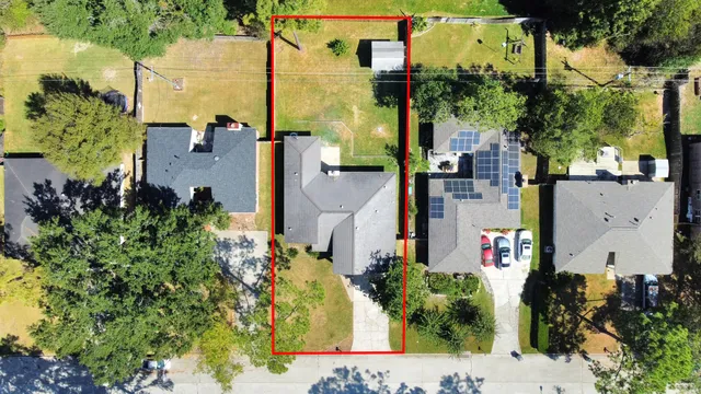 an aerial view of a house with a yard and garden