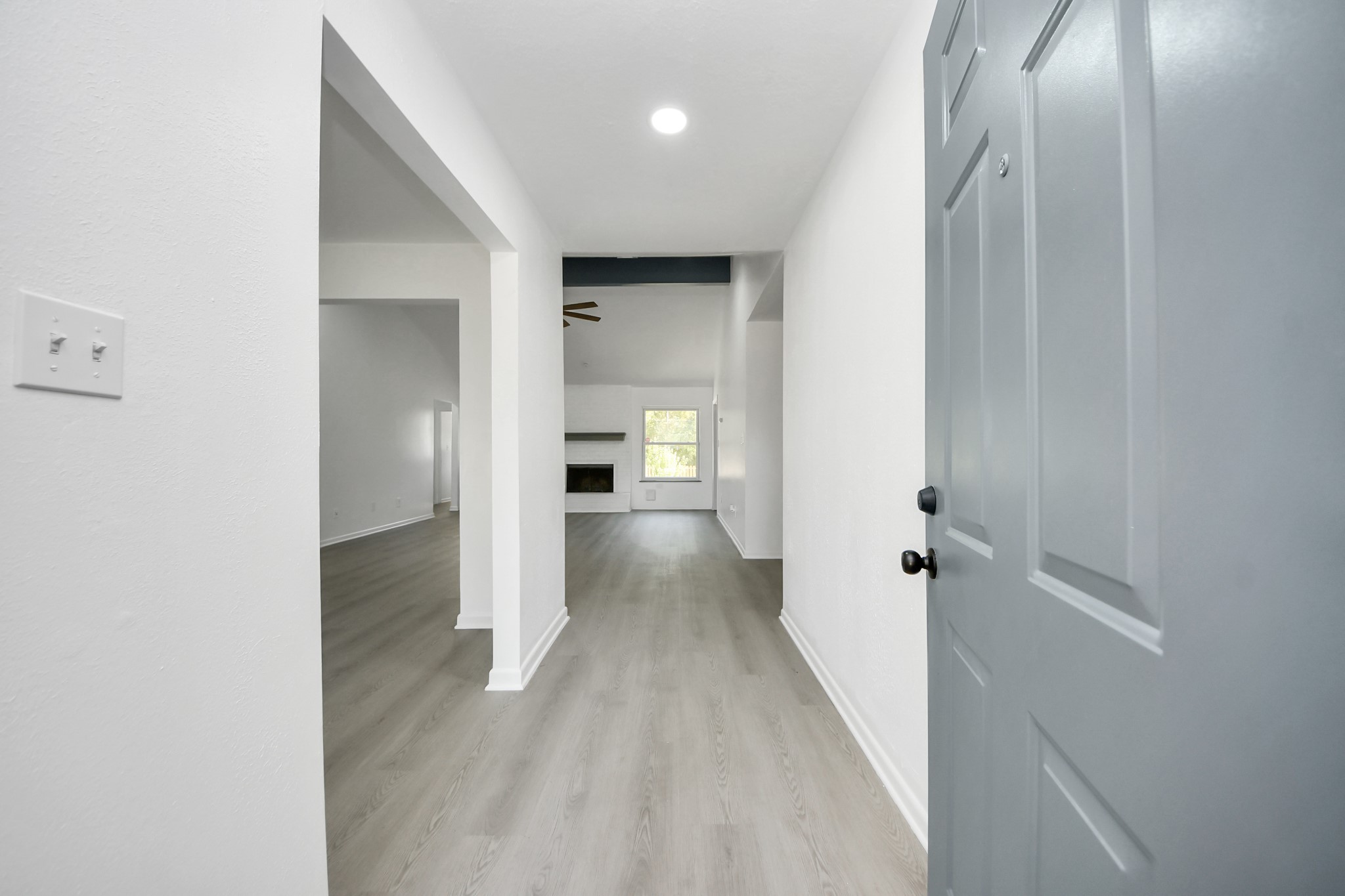 23002 Grand Rapids Lane Spring, TX 77373 - Photo 8 of 41 a view of a hallway with wooden floor and a bathroom
