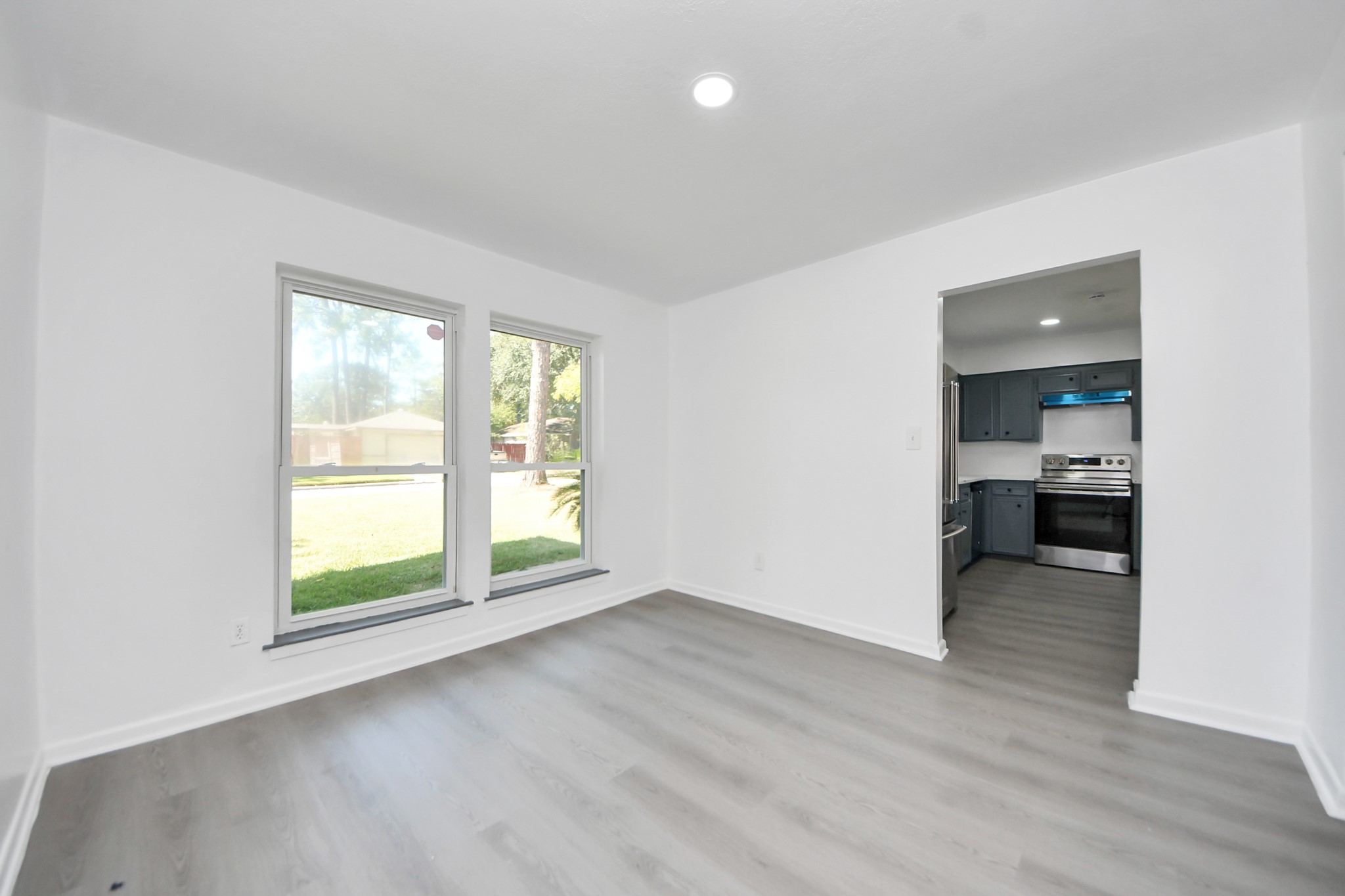 23002 Grand Rapids Lane Spring, TX 77373 - Photo 9 of 41 an empty room with wooden floor and a window