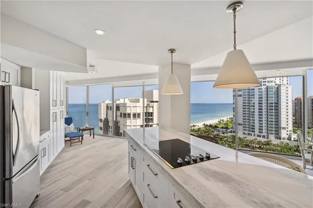 a kitchen with stainless steel appliances granite countertop a stove a refrigerator and a wooden floors