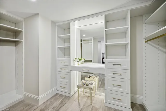 a spacious bedroom with two beds and lamp