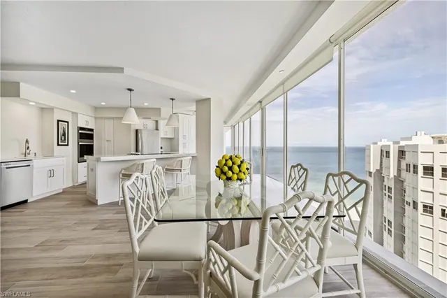 a view of a dining room with furniture a chandelier and wooden floor