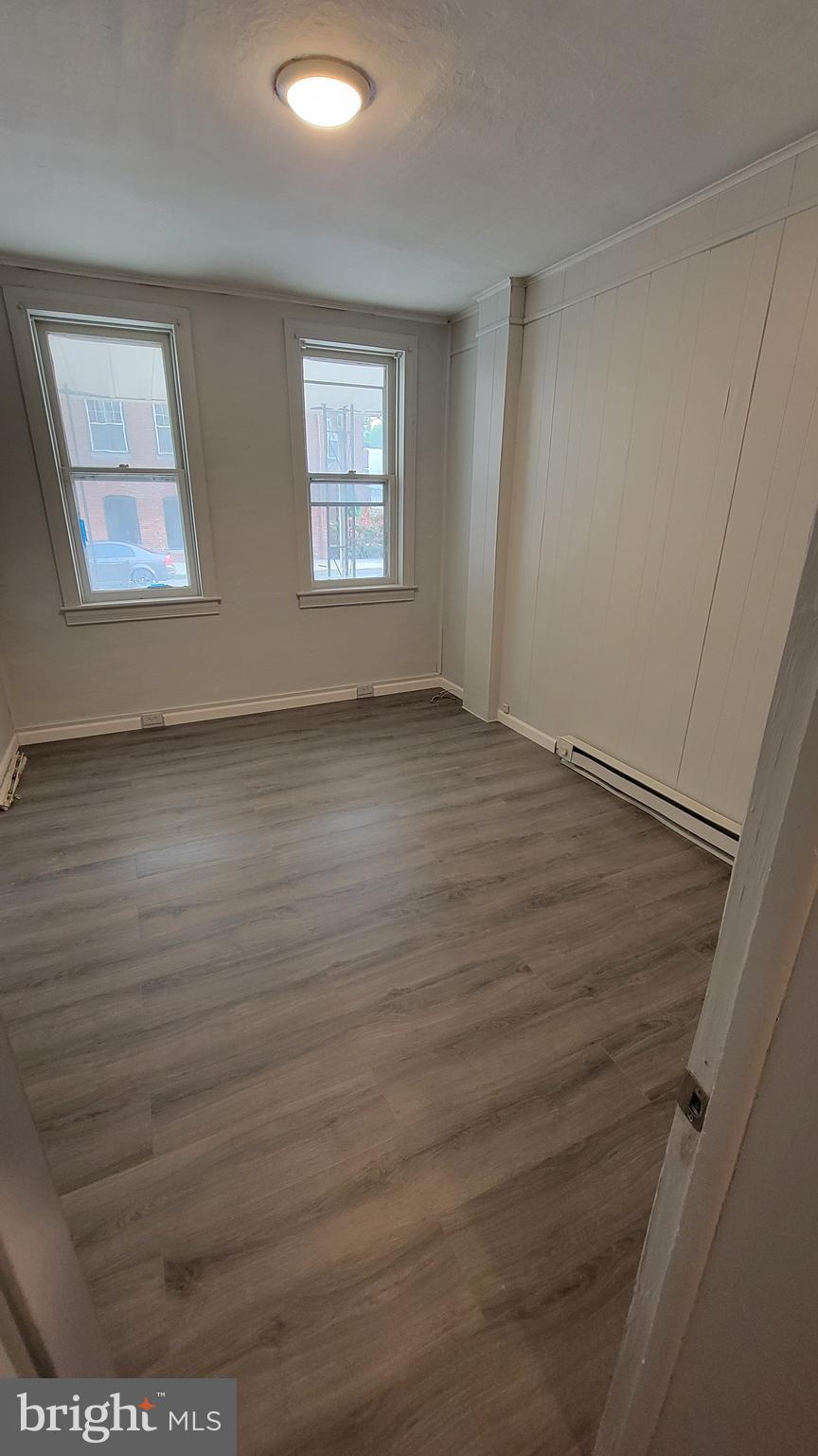 627 North Hartley Street York, PA 17404 - Photo 2 of 10 a view of an empty room with wooden floor and a window