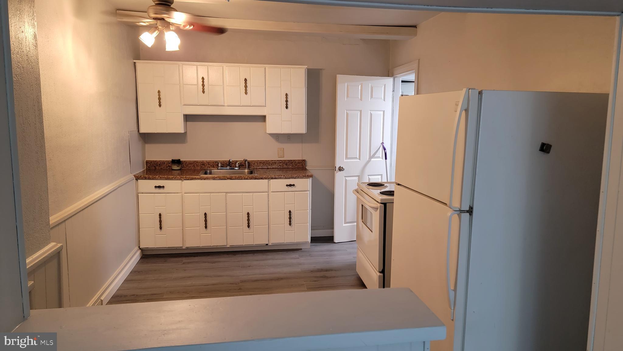 627 North Hartley Street York, PA 17404 - Photo 6 of 10 a kitchen with stainless steel appliances a refrigerator a stove a sink and white cabinets