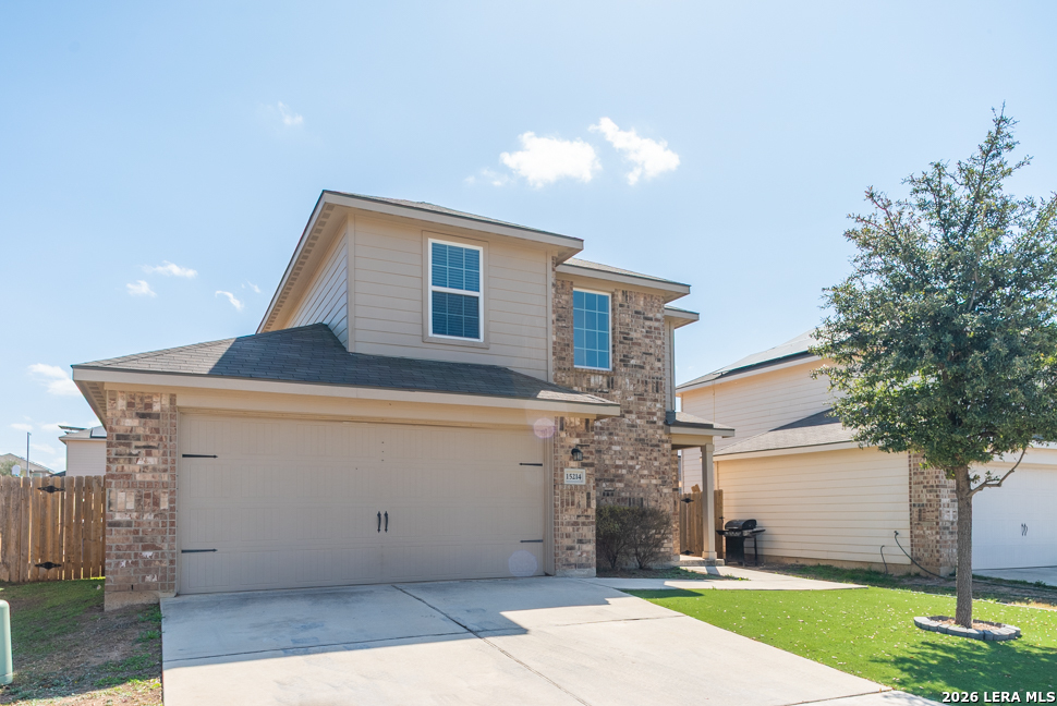 a front view of a house with a yard and garage