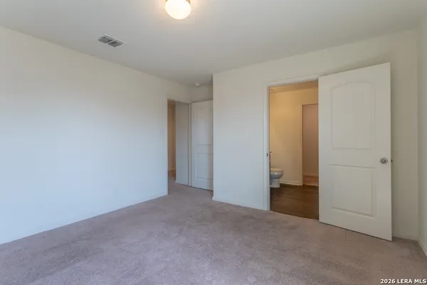 a bathroom with a granite countertop sink a toilet and a mirror
