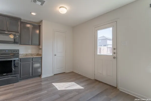 a view of a kitchen with a sink and a stove top oven
