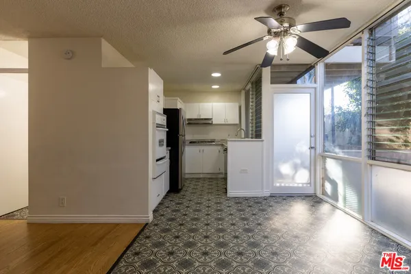 a view of a kitchen with a sink and a refrigerator