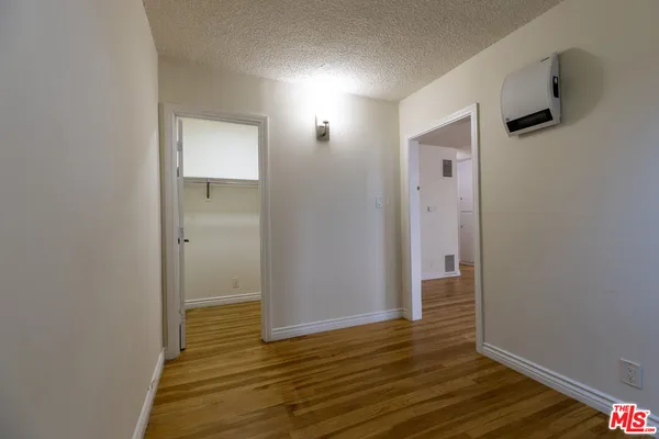 a view of hallway with wooden floor
