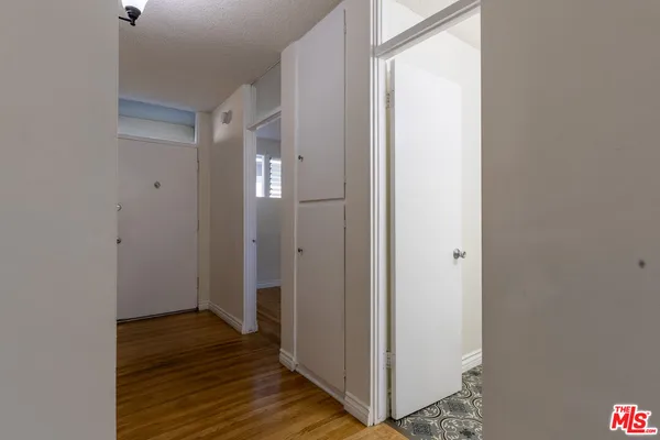 a view of a hallway with wooden floor