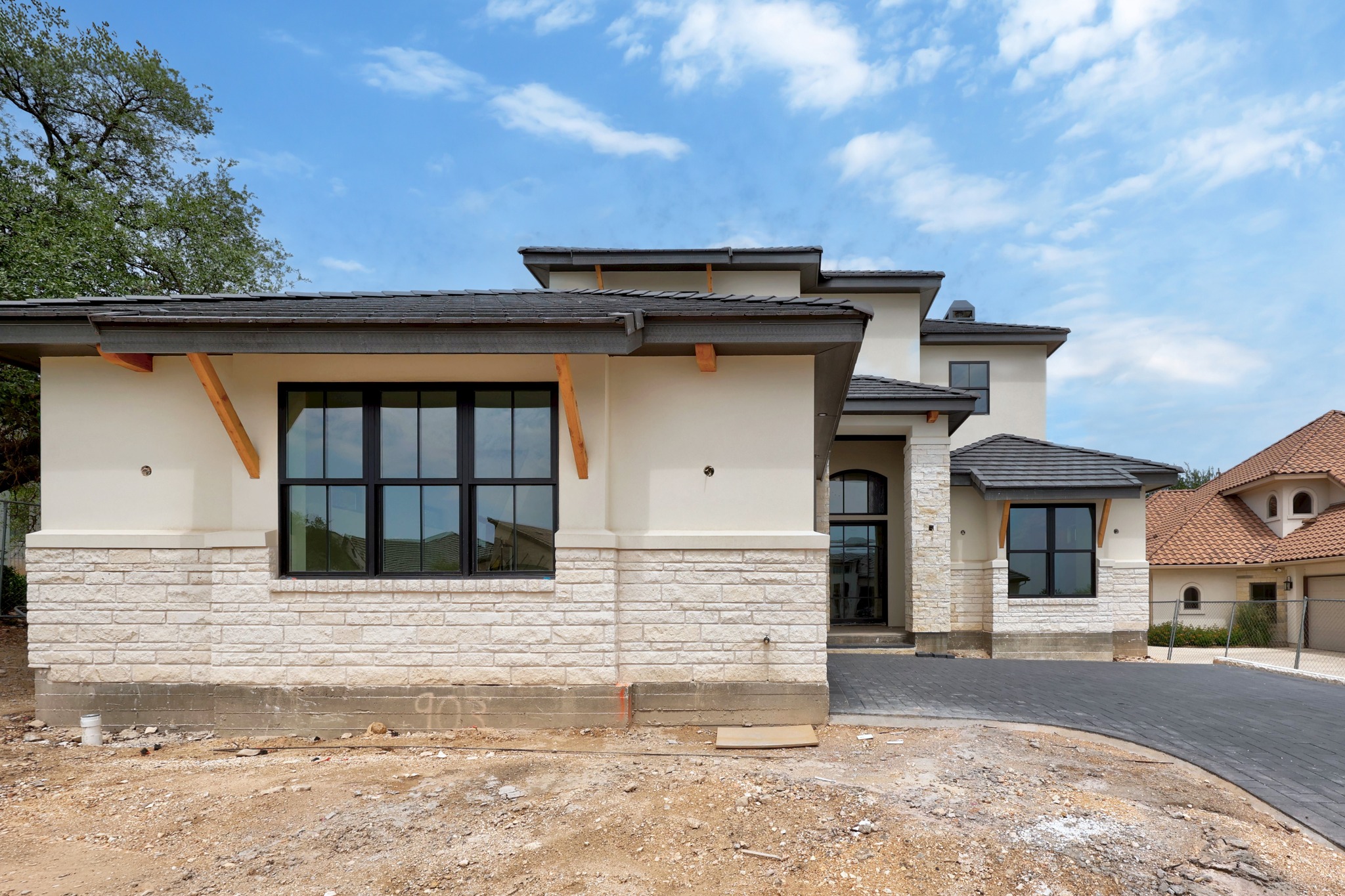903 Flint Ridge Trail Georgetown, TX 78628 - Photo 3 of 39 Contemporary exterior featuring light-colored stucco and stacked stone accents