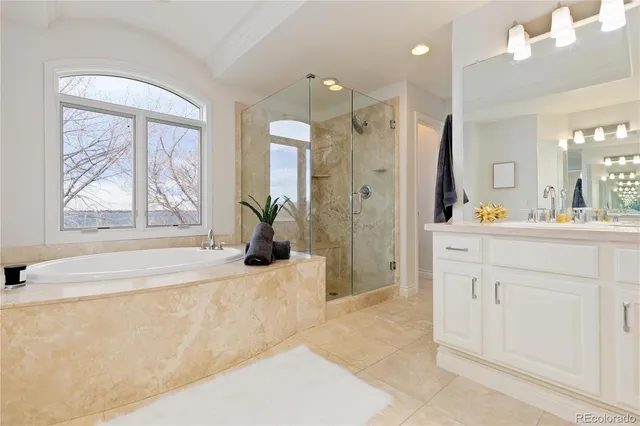 a spacious bathroom with a granite countertop sink a mirror and a