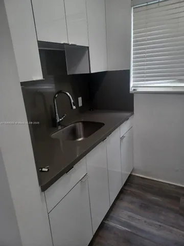 a kitchen with sink and cabinets