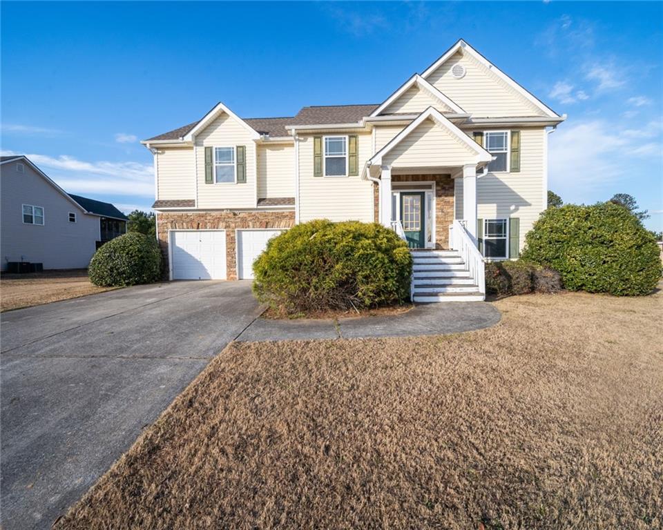 a front view of a house with a yard and garage