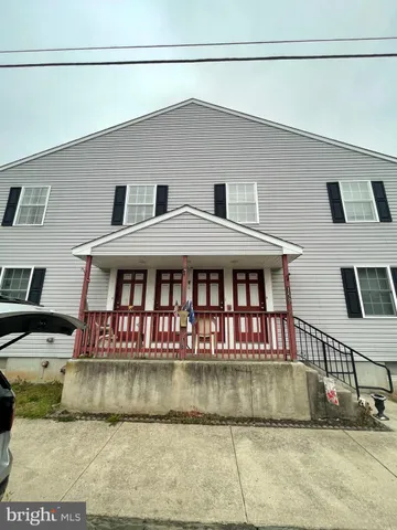 a view of house with a yard and swimming pool