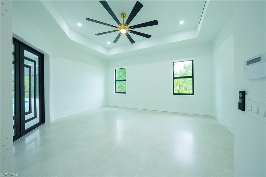 522 17th Street Southwest Naples, FL 34117 - Photo 14 of 48 an empty room with windows and fan