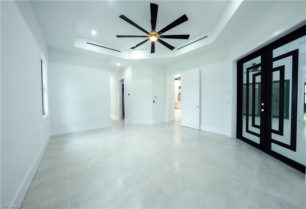 522 17th Street Southwest Naples, FL 34117 - Photo 15 of 48 an empty room with ceiling fan and windows