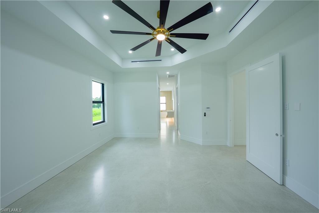 522 17th Street Southwest Naples, FL 34117 - Photo 16 of 48 an empty room with windows and fan