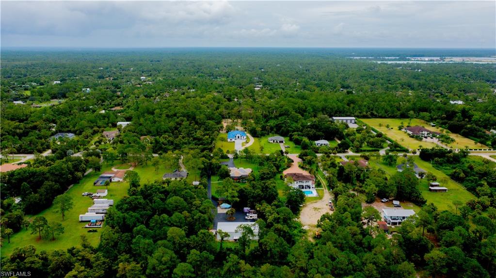 522 17th Street Southwest Naples, FL 34117 - Photo 2 of 48 a view of a large yard with lots of green space