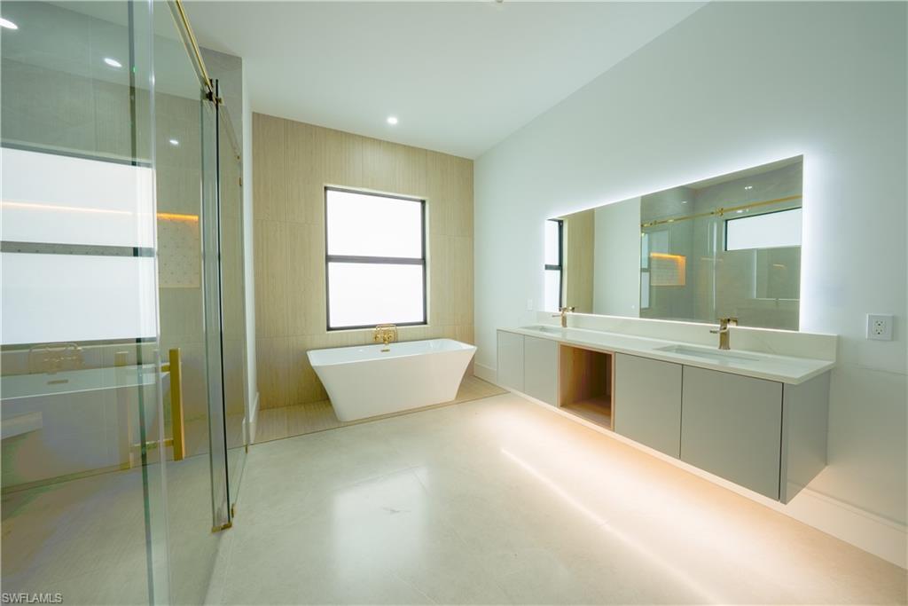 522 17th Street Southwest Naples, FL 34117 - Photo 20 of 48 a large bathroom with a large tub and sink