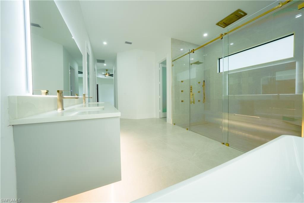 522 17th Street Southwest Naples, FL 34117 - Photo 22 of 48 a bathroom with a shower sink and mirror