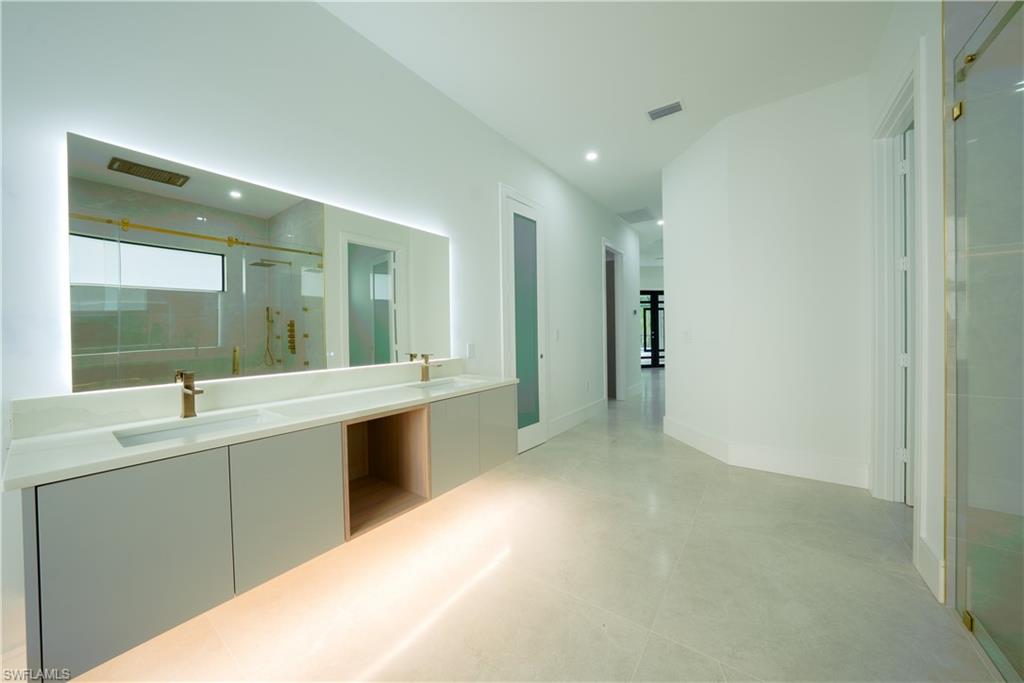 522 17th Street Southwest Naples, FL 34117 - Photo 23 of 48 a large bathroom with a sink mirror and a bathtub