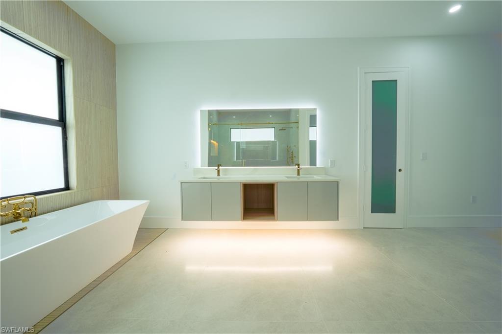 522 17th Street Southwest Naples, FL 34117 - Photo 24 of 48 a view of a bathroom with a tub sink and mirror