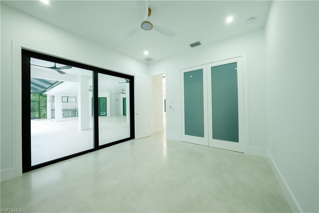 522 17th Street Southwest Naples, FL 34117 - Photo 32 of 48 a view of an empty room with a sliding door and balcony
