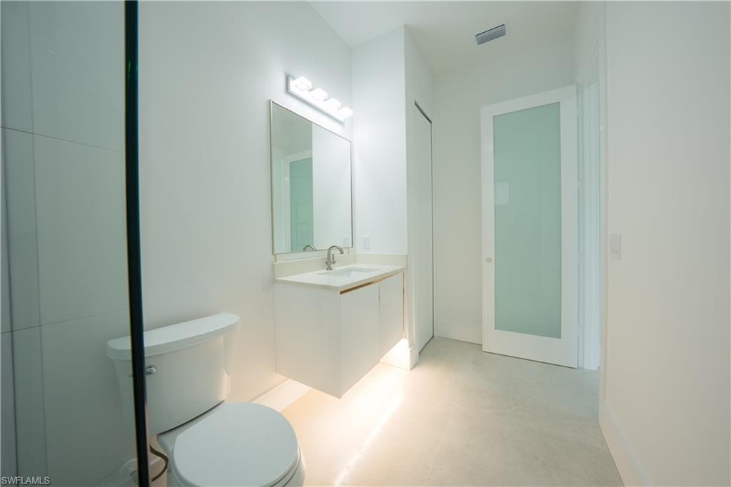 522 17th Street Southwest Naples, FL 34117 - Photo 35 of 48 a bathroom with a sink a toilet and mirror
