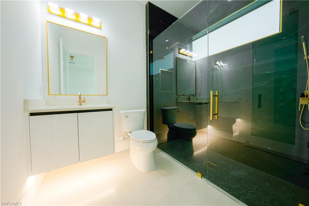 522 17th Street Southwest Naples, FL 34117 - Photo 39 of 48 a bathroom with a sink and a mirror