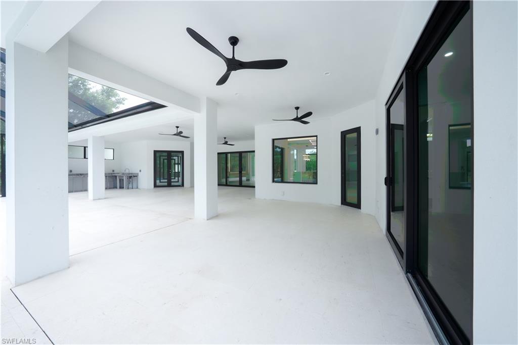 522 17th Street Southwest Naples, FL 34117 - Photo 46 of 48 a view of a hallway with chandelier and glass door