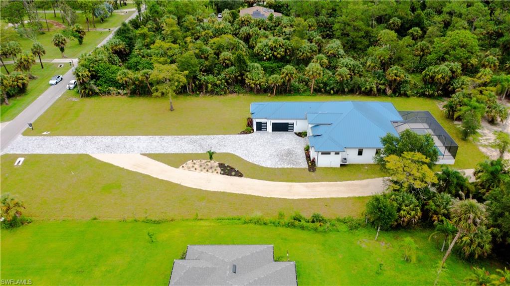 522 17th Street Southwest Naples, FL 34117 - Photo 7 of 48 a view of a swimming pool with a yard