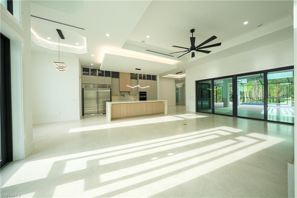 522 17th Street Southwest Naples, FL 34117 - Photo 8 of 48 a large white kitchen with a large window and stainless steel appliances