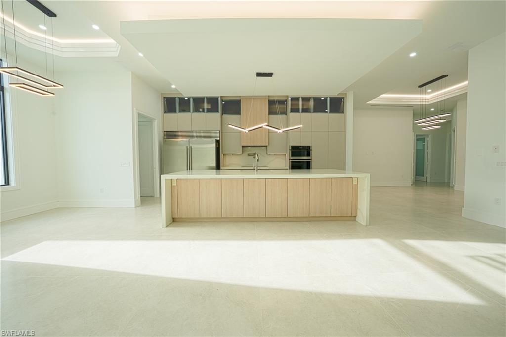 522 17th Street Southwest Naples, FL 34117 - Photo 9 of 48 a view of a kitchen with furniture and wooden floor