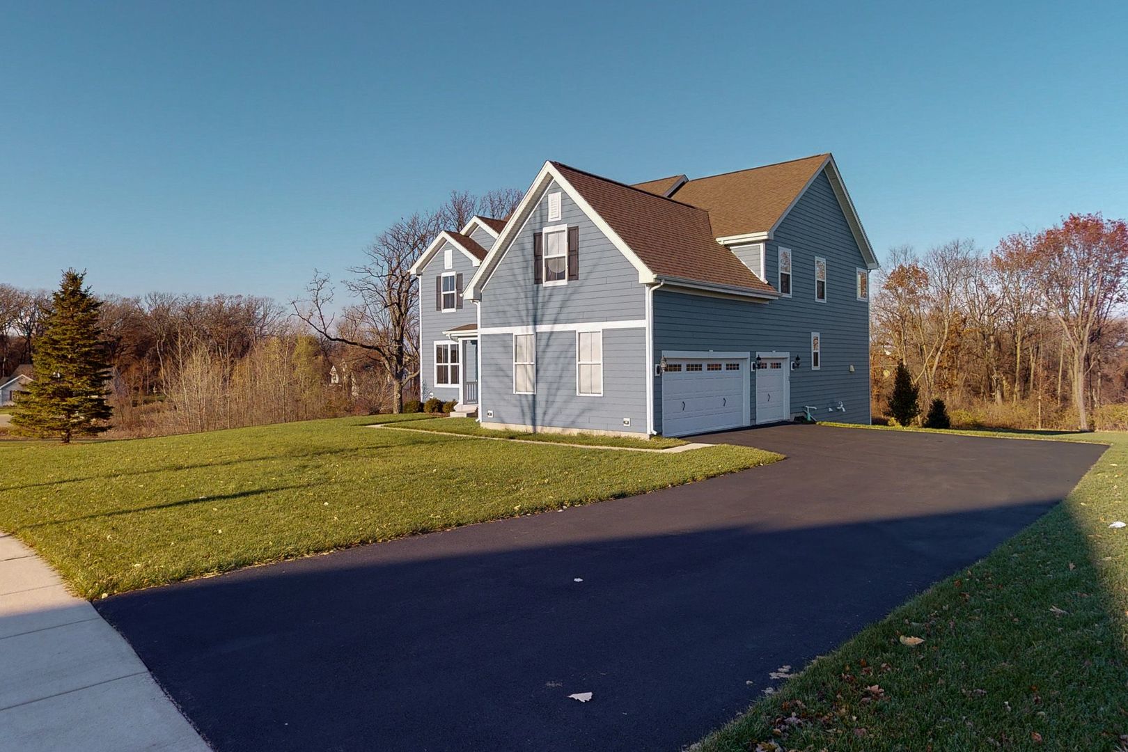4362 Rudyard Kipling Road Elgin, IL 60124 - Photo 2 of 33 a view of a house with a yard and garage