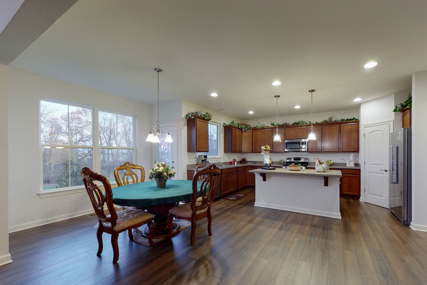 4362 Rudyard Kipling Road Elgin, IL 60124 - Photo 6 of 33 a kitchen with a dining table chairs and refrigerator